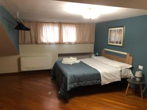 a bedroom with a bed in a room with blue walls at La dimora degli Artisti in Foggia