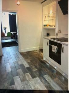 a kitchen with a stove and a counter top at The Courtyard in Wells +2 photos