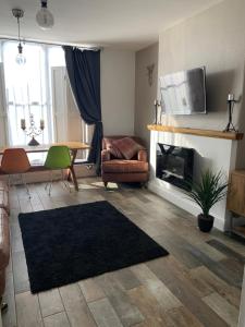 a living room with a couch and a fireplace at The Courtyard in Wells