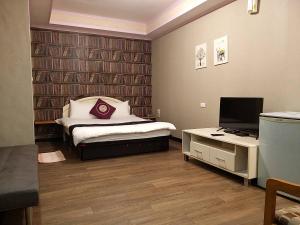 TV a/nebo společenská místnost v ubytování Guan Lun Hotel