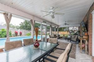 a living room with a table and a pool at Coastal Retreat home in Navarre