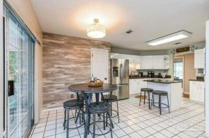 a kitchen with a table and some stools in it at Coastal Retreat home in Navarre