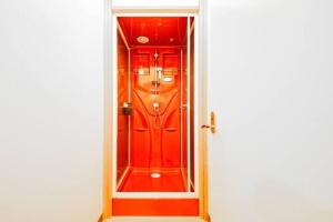 a red door in a white room with at NUPURI in Otaru