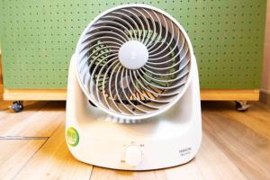 a white electric fan sitting on a wooden floor at NUPURI in Otaru +23 photos