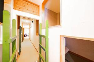 a room with green doors and a hallway at NUPURI in Otaru