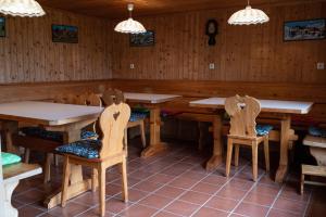 a dining room with wooden tables and chairs at Appartement Haus Kruschitz I in Ludmannsdorf +21 photos