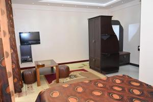 a bedroom with a bed and a tv in a room at Mayisyan Kamurj Hotel in Ijevan