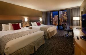 a hotel room with two beds and a large window at Warwick Seattle in Seattle