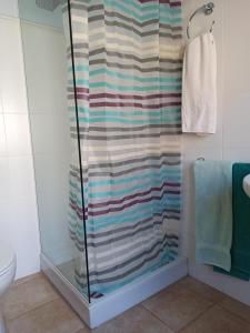 a shower with a striped shower curtain in a bathroom at Pagés in Sant Climent Sescebes +19 photos