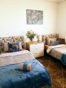 A bed or beds in a room at La Zenia Holiday Home