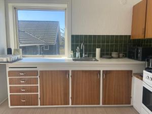 a kitchen with a sink and a window at Viking Surf House in Klitmøller
