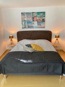 a bedroom with a large bed with two lamps at Porturama in Mouronho +40 photos