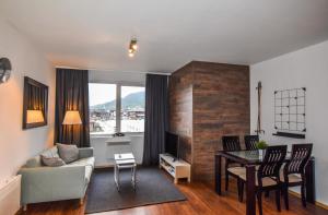 a living room with a couch and a table at Bansko Royal Towers Apartments - Gondola View in Bansko