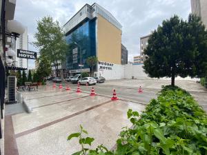 a parking lot with cones in front of a building at Bugday Hotel in Ankara