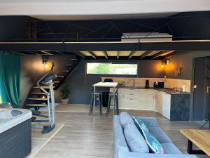 a living room with a loft bed and a kitchen at Charmant logement avec jacuzzi in Salon-de-Provence