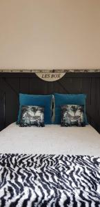 a zebra print bed with two pillows on it at les Box in Figeac