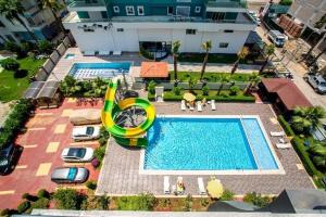 an overhead view of a swimming pool with a pool slide at Cozy fancy Sea view next to the Beach and the Mall, in the mid of Alanya Mahmutlar! in Alanya