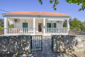 a house with a gate in front of it at House Sun and Sea in Olib