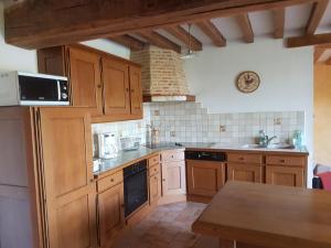 a kitchen with wooden cabinets and a counter top at Gaëtan in Lainsecq