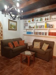 a living room with two couches and a coffee table at Rincon de Sandra in Monteagudo de las Salinas