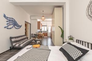 a bedroom with a bed and a living room at Flèria Seaview Suites in Naxos Chora