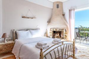 a bedroom with a bed with a fireplace at Gregory's House in Monemvasia