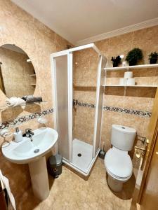 a bathroom with a shower and a toilet and a sink at Sunny Escape in El Campello in El Campello