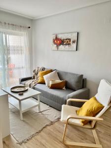 a living room with a couch and a table at Sunny Escape in El Campello in El Campello