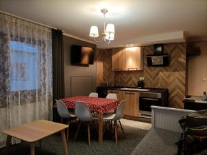 a kitchen and dining room with a table and chairs at Willa na Wilcznik in Zakopane