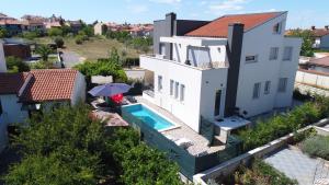 an aerial view of a house with a swimming pool at Apartments Peti in Pula