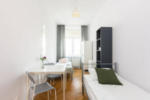 a living room with a white couch and a table at Rooms Nearto Main Square in Krakow