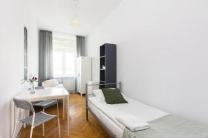 a bedroom with a bed and a desk and a table at Rooms Nearto Main Square in Krakow