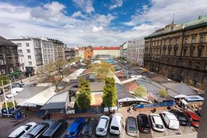 a parking lot filled with parked cars in a city at Rooms Nearto Main Square in Krakow