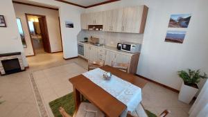 a kitchen with a table and chairs in a room at Free SPA в Св. Иван Рилски - Сладък дом сред лукс in Bansko