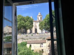 a view of a church from a window at LES QUAIS DE NERAC in Nérac