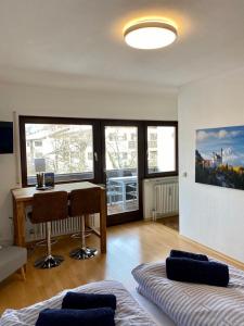 a living room with a table and a desk in it at Apartment Colonia in Garmisch-Partenkirchen