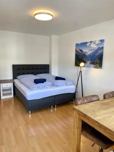 a bedroom with a bed and a table in it at Apartment Colonia in Garmisch-Partenkirchen