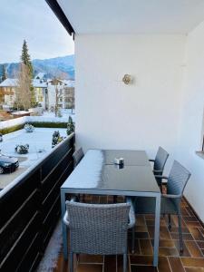 a table and chairs on a balcony with a view at Apartment Colonia in Garmisch-Partenkirchen