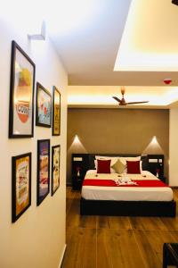 a bedroom with a bed and some pictures on the wall at Igloo Heritage Resorts in Idukki