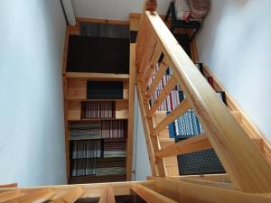 a wooden staircase with a book shelf of dvds at Las Estrellas de Laguarta in Laguarta
