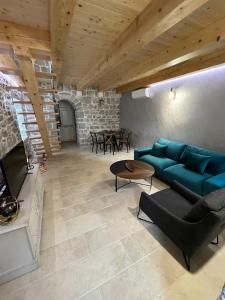 a living room with a blue couch and a fireplace at Casa Vecchia in Kotor