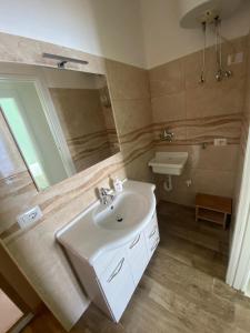 a bathroom with a sink and a mirror at Nel blu dipinto di blu in Scilla