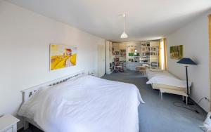a white bedroom with a white bed and a desk at Feriendomizil Villa Bomama in Ebern