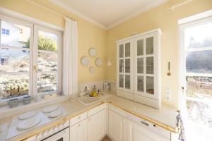 a large kitchen with a sink and two windows at Feriendomizil Villa Bomama in Ebern +26 photos