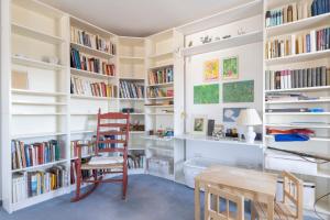a room with white shelves filled with books at Feriendomizil Villa Bomama in Ebern