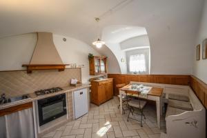 a kitchen with a table and a stove top oven at MaLu in Levico Terme