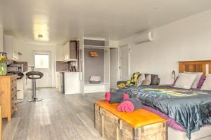 a bedroom with a large bed and a kitchen at 43 annexe in Newquay