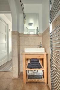 a bathroom with a sink and a counter with towels at 43 annexe in Newquay