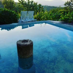 two chairs sitting next to a swimming pool at Quinta Casa Do Quintal in Lamego