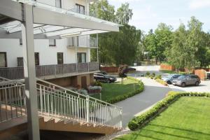 a apartment building with a balcony and a parking lot at Apartament Oliver in Darlowko